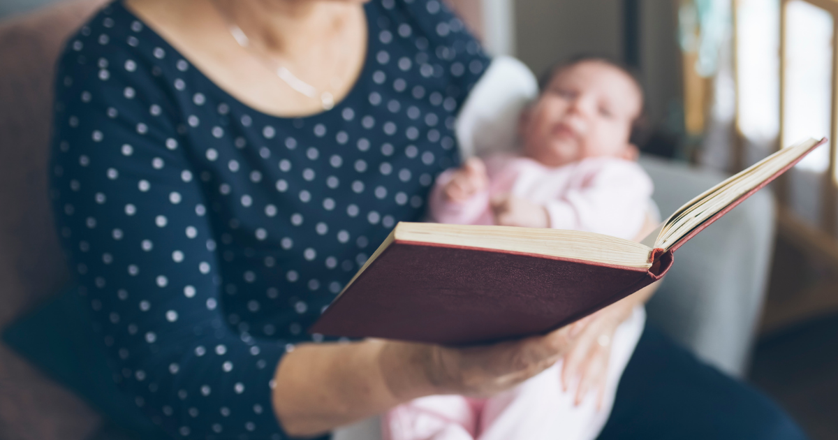 Grandmother reads to infant in recognition of National Reading Month